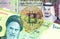 Saudi Arabia Riyal banknote with King Salman, Iranian rial banknote with Ayatollah Khomeini and translucent Bitcoin
