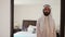 Saudi arabian man dressing at home