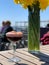 Sauer pomegranate on a wooden board on a table in an outdoor cafe. Sunny day. Blur, defocus, soft focus