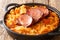Sauerkraut baked with onions, bacon, carrots and smoked pork in a skillet. horizontal