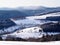 Sauerland, Germany - Winter landscape with snow-covered wooded hills and fields