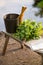 Sauna objects on wooden bench before lake at summer