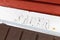 Sauna sign on white wooden plank