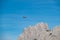 Sauris - Small airplane flying over the majestic mountain ridges of Carnic Alps near Sauris di Sopra