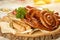 Sausage assortment dish on round wooden plate.