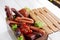 Sausage assortment in wooden box white background