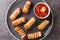 Sausage baked in pastry mummy food for Halloween party or children`s holiday closeup in the plate. Horizontal top view