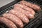 sausage cooking herbs on an electric bbq