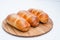 Sausage in dough close - up on a white. Isolated