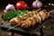 sausage and onion kebabs cooked golden brown on rustic wood table