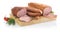 Sausage, piece of ham and slices on wooden bord isolated on whit