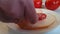 Sausage salami falls on a wooden background tomato, hands, bread