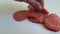 Sausage salami slow-motion shooting, hand