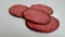 Sausage salami on a white background falls, slowed down shooting