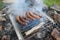 Sausages Cooking Over an Open Charcoal Grill