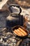 Sausages fries and teapot boils at bonfire coals. cooking at campfire. Trekking or hiking cuisine