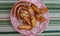 Sausages and halves of potatoes fried over the fire are laid out on a plate in the fresh air