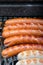 Sausages roasting on a grill