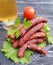 Sausages salad leaf pork board portion tomato organic traditional dinner gourmet kitchen on a wooden background lettuce table