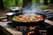 sausages sizzling on a portable camping hibachi