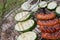 Sausages and zucchini  being barbequed