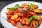 Sauteed seafood on a white plate, on a dark background