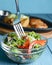 Sauteed vegetable salad with broccoli, asparagus, sweet pepper and cellophane noodles or fensi noodles in a glass bowl