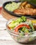 Sauteed vegetable salad with broccoli, asparagus, sweet pepper and cellophane noodles or fensi noodles in a glass bowl