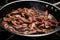 sauteing beef strips in a hot stainless-steel pan