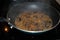 Sauteing mushrooms and onions in a frying pan with oil, seasoning, and steam