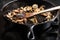 Sauteing sliced mushrooms in a skillet