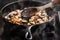 Sauteing sliced mushrooms in a skillet