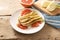 SautÃ©ed fennel vegetable with grapefruit slices, vegetarian meal on a white plate, ingredients and a blue kitchen towel on rustic