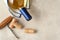 Sauvignon Blanc bottle wrapped in a towel on a gray tile surface with corks and antique corkscrew