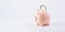 Save currency bitcoin. Pink pig bank with golden bit coin money BTC on white background. Save money investment and