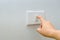 Save electricity Close up of finger is turning on or off on light switch. woman hand with finger on light switch Copy space.