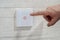 save energy concept,closeup of finger touching to electric switch. man\'s finger presses a touch-sensitive modern switch on a whit
