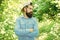 Save environment. Eco activist. Man handsome bearded guy in sunny forest. United with environment. Go green think fresh