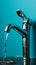 Save water conceptmetallic faucet with single drop blue background