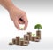 Saving money concept preset by Male hand holding money coin stack growing business