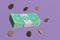 Saving money financial goal concept: Bundles cash and floating coins around on purple background. depicts money saving, cashless