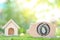 Saving money for prepare in future and new house concept, Piggy bank wood with model house on natural green background