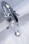 Saving water: Close up of spigot with clear, flowing water