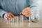 Savings, money and banking done by a business person on a table in an office at work alone. Closeup of the hands of a