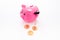 Savings. Moneybox in shape of pig near coins on white background copy space