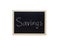 Savings written with white chalk on blackboard