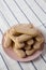 Savoiardi or ladyfingers cookies on pink plate, low angle view. Closeup. Copy space