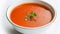 Savoring the Simplicity: A Scrumptious Bowl of Tomato Soup on a White Canvas