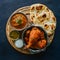 Savory Bangladeshi chicken tandoori and tikka served with garlic naan