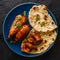 Savory Bangladeshi chicken tandoori and tikka served with garlic naan